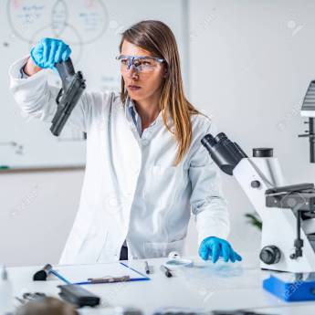 Forensic science expert examining gun collected at a crime scene